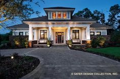 a large white house with lots of lights on it's front door and windows