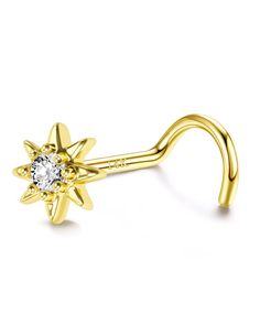 a gold nose piercing with a diamond in the center and an open star design on it