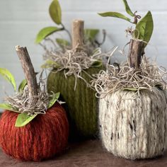 three knitted pumpkins sitting next to each other