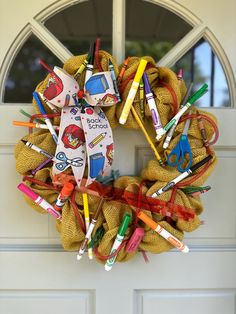 a wreath made out of burlocks and crayons on the front door