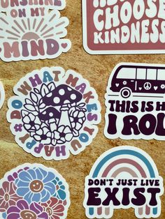 various stickers with different sayings and symbols on the side of a wooden surface