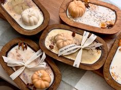 four wooden trays filled with different types of desserts on top of a table