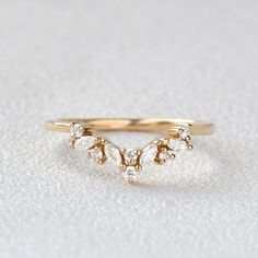 a gold ring with three small diamonds on it