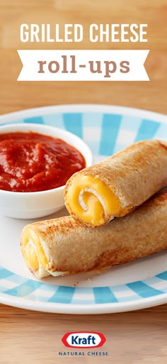 grilled cheese roll - ups on a blue and white plate with ketchup