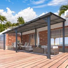 an outdoor covered patio with furniture and palm trees in the backgroung area