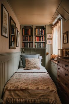 a bed sitting in a bedroom next to a book shelf filled with lots of books