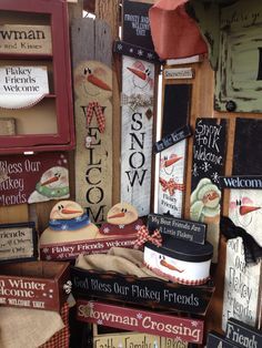 a pile of wooden signs sitting on top of a table