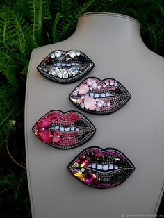 four different colored lips are on a display