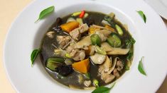 a white bowl filled with soup on top of a table