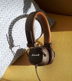 headphones are sitting on top of a pillow