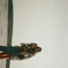 two people standing next to each other near a tree