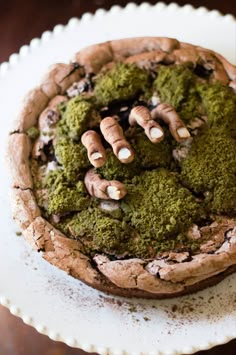 there is a chocolate cookie with green toppings on it