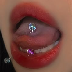 a woman's nose with piercings on top of her lip and the bottom part of her mouth