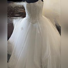 a white wedding dress on display in a store