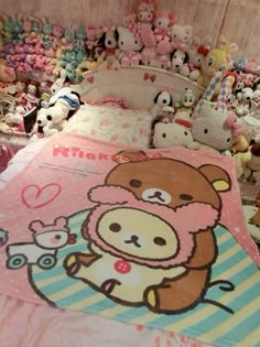 there is a bed with many stuffed animals on it and one has a teddy bear