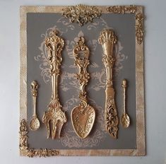 an ornately decorated wall hanging with golden spoons and forks