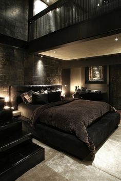 a large bed sitting in the middle of a bedroom next to a stair case with lights on it