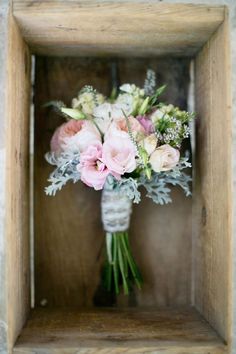 a vase filled with pink and white flowers