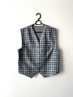 "Vintage Large classic women's vest Wool blend plaid vest Women's formal vest Blue Checkered  Waistcoat Button Up office Vest Estimated size: L Measurements (lying flat): Length: 21\"/ 53.5 cm Pit to pit: 20\"/ 50.7 cm Waist: 20.\"/ 50.7 cm Please check measurements to insure a proper fit. Remember to allow yourself some extra room for movement. You can compare these with something from your closet that fits you well. This vest will come to you freshly laundered and ready to wear. Please convo me if you need additional measurements. Condition: great Vintage Condition SHIPPING * I ship worldwide via Priority mail (Latvijas Pasts) from Latvia (EU). * I ship from Europe, so please allow 2 to 4 weeks for the package to arrive if you live overseas. * Europe 5 - 10 business days. Thanks for the Classic Wool Vest For Office, Classic Plaid Vest For Fall, Fitted Plaid Vest For Winter, Sleeveless Vest For Business Casual Winter, Classic Plaid Vest, Classic Plaid Sleeveless Vest, Classic Sleeveless Plaid Vest, Plaid Sleeveless Vest For Work, Fitted Plaid Sleeveless Vest