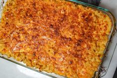 macaroni and cheese in a glass casserole dish on a white table