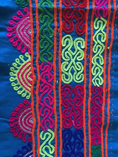 an embroidered cloth with many colors and designs on it