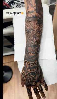 a person with tattoos on their arm and hand