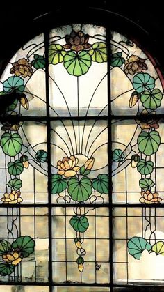 a stained glass window with flowers and leaves