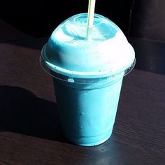 a blue drink sitting on top of a wooden table