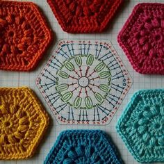 four crocheted hexagons are arranged on a sheet of paper