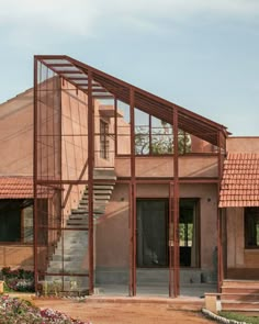 a house that is made out of wood and metal with stairs leading up to the front door