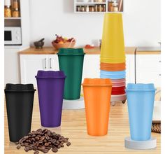 there are many different colored cups on the table