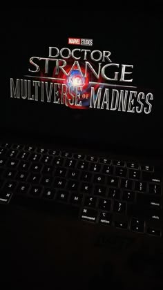 a laptop computer sitting on top of a desk with the title doctor strange multiverse madness