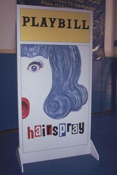 there is a sign that says, playbill hair spray on it's side