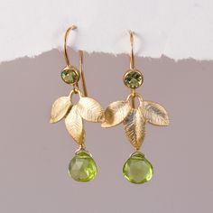 "Dainty Peridot Earrings Gold, Mother of the Bride Earrings, August Birthday Gift, Elegant Leaf Dangle, Meaningful Jewelry Gift, Birthstones Simple and elegant, these earrings feature a tiny birthstone wire wrapped onto a stunning gold or silver plated leaf charm with a matching stone on top. Available in 6 different stone & color options, these earrings make ideal gifts! H O W ∙ T O ∙ O R D E R 1st DROP DOWN menu * Select which of the stones you would like on your necklace (See listing phot Mother Of The Bride Earrings, Earring Tops, August Birthday, Peridot Jewelry, Peridot Earrings, Personal Aesthetic, Bride Earrings, Birthstone Earrings, August Birthstone