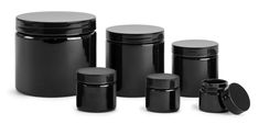 black plastic jars with lids are lined up