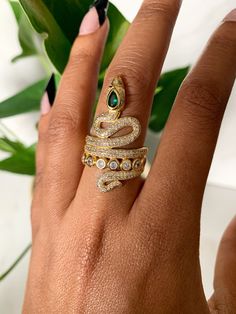 This gorgeous ring is 18kt gold plated and adjustable. Gold Emerald Ring With Vs Clarity In 14k Gold, Gold Cubic Zirconia Open Emerald Ring, Adjustable Gold Gemstone Rings, Unique Gold Crystal Promise Ring, Unique Gold Cubic Zirconia Rings, Unique Gold Rings With Cubic Zirconia, Gold Emerald Ring With Vs Clarity For Wedding, Gold Snake Open Ring Fine Jewelry, Gold Open Snake Ring Fine Jewelry