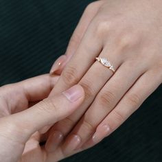 two people holding each other's hands while they hold their wedding rings on their fingers