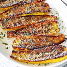 grilled eggplant on a white plate with parsley