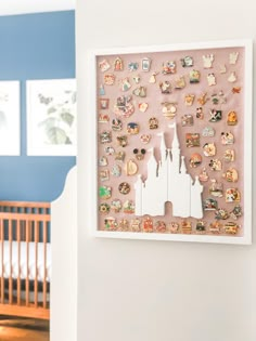 a white frame with pins on it and a crib in the background