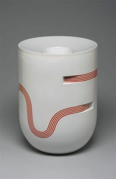 a white bowl with red lines on the outside and inside, sitting on a gray surface