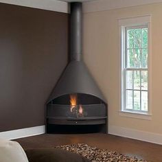 a living room with a fire place in the corner and wood chips on the floor