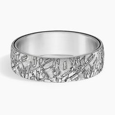 a wedding band with an etched design on it