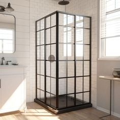 a bathroom with a shower, sink and mirror