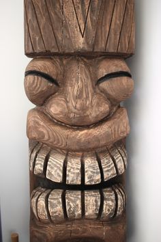 a wooden carved totem sitting on top of a table