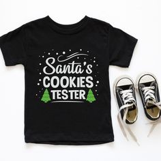 Santa's cookies tester t-shirt for kids. Adorable baking shirt for kids this holiday season! Who is the official cookie tester in your family? Please see the size chart for more info. Thank you for supporting our small business :) Kids will love this custom youth short sleeve tee. This lightweight (4.0 oz) side-seamed shirt maximizes comfort all day long. The ring-spun cotton makes this kids short sleeve tee perfect for displaying custom artwork. Side seams keep the garment's shape. The shoulder Kids Christmas T Shirts, Girls Christmas Shirts, Twin Shirts, Santa Cookies, Santa Shirts, Kids Shorts, Christmas Girl, Christmas Tshirts, Kids Tops