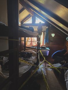 there are two bunk beds with caution tape on the floor in this attic dormer