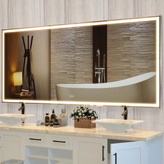 a bathroom with two sinks and a large mirror on the wall above it that has a bathtub in front of it