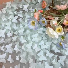 some flowers are laying on a table with white and pink petals in it's center