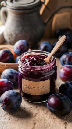 plum jam in a jar surrounded by plums