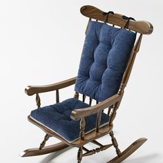 a wooden rocking chair with blue cushions